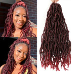 Collage showing a woman wearing burgundy/red faux locs styled half-up with a bow, alongside a matching bundle of burgundy ombré locs hair extensions held at the top on a white background.