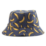 Navy blue bucket hat with an all-over yellow banana print on a white background.