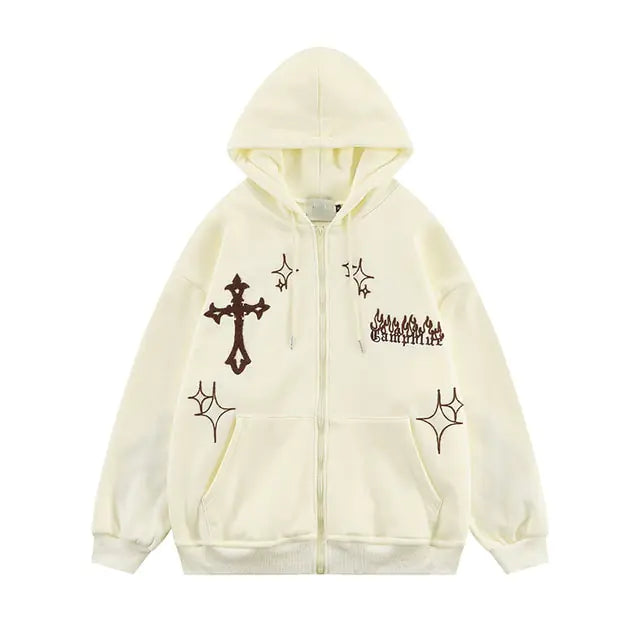 Cream zip-up hoodie with a cross graphic, star motifs, and gothic-style text.
