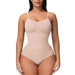 Front view of a model wearing a nude-colored seamless shapewear bodysuit with thin adjustable straps and high-cut leg openings on a white background.