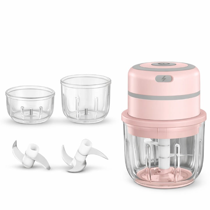 Pink handheld blender with clear containers and attachments on a white background