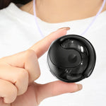Person holding a small black device with a white background