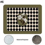 A black Super Absorbent Drain Pad placed on a kitchen countertop with a coffee maker and dishes in the background.