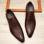 Dark brown pointed-toe lace-up dress shoes with an embossed crocodile-style texture.
