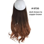 Long wavy hair extension piece in an ombré color, dark black at the top fading to light brown at the ends, shown on a white background.