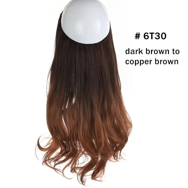 Long wavy hair extension piece in an ombré color, dark black at the top fading to light brown at the ends, shown on a white background.