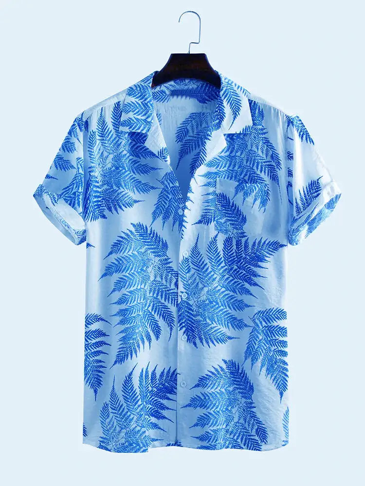 Light blue short-sleeve button-up shirt on a hanger, patterned with bright blue fern leaves and an open collar.