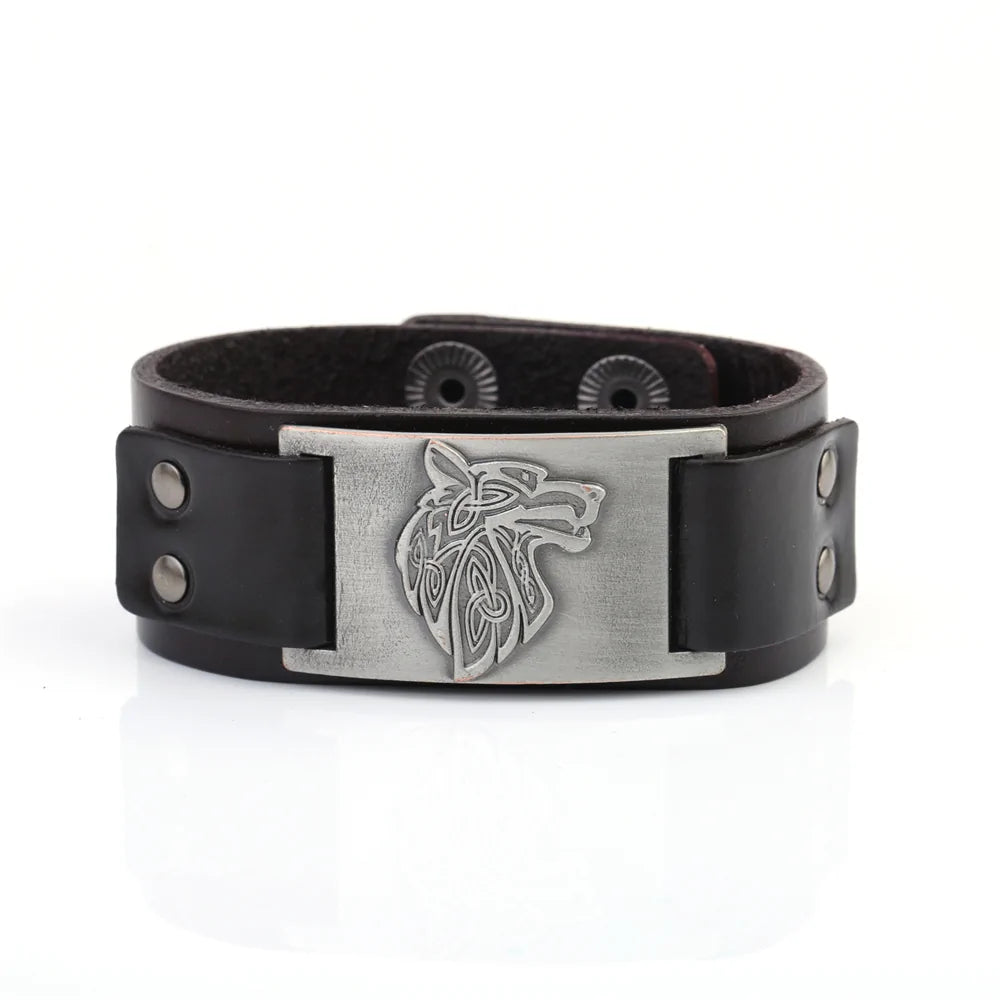 Black braided leather wristband bracelet with a rectangular silver-toned plate engraved with a Celtic-style wolf head, fastened with snap buttons.