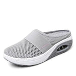 A single slip-on mesh sneaker with a white sole and air-cushion heel, featuring a breathable upper, an elastic band across the top for support, and the word “FASHION” printed on the side.