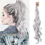 A side-by-side product-style image showing a woman in profile wearing a high ponytail with long, wavy silver/gray hair, next to a matching silver/gray wavy ponytail hair extension being held up by a hand on a white background.