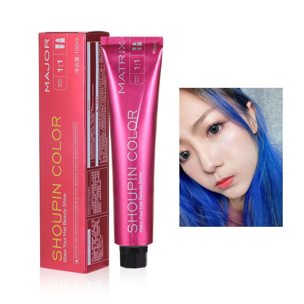A tube of Shoupin Color hair dye (100ml, pink packaging) beside a photo of a woman with bright blue hair, showcasing the color effect. The box includes the instructions "Make Your Hair Beauty Shine.