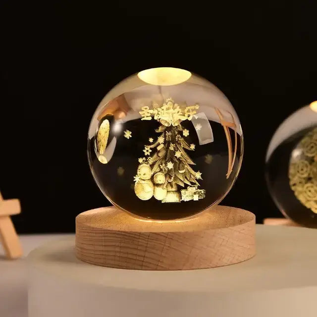 A glowing crystal ball lamp with a golden spiral galaxy design inside sits on a wooden base, softly illuminated, with a small astronaut figurine standing in the background against a dark backdrop.