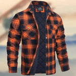 A dark brown men's pullover sweater with a textured cable knit pattern on the front. The sweater features a high ribbed collar with tan brown buttoned detailing, ribbed cuffs and hem, and matching tan elbow patches. The background consists of distressed, multicolored metal panels.