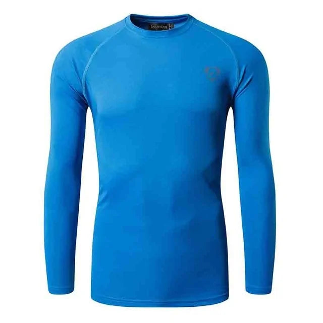 A vibrant blue, long-sleeved athletic compression shirt with a crew neck. The shirt has a subtle logo on the upper left chest and appears to be made from a stretchy, moisture-wicking fabric, designed for sports or active wear.