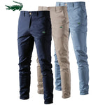 A pair of slim-fit pants with a button closure, belt loops, and side pockets. The fabric appears to be lightweight, suitable for casual or semi-formal wear.