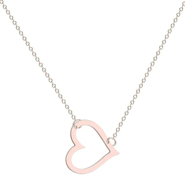 A delicate gold chain necklace featuring a tilted, hollow heart-shaped pendant. The heart is asymmetrically attached at both top curves to the chain, giving it a stylish slant. The background is plain white, highlighting the necklace's elegant and minimalist design.