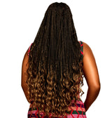 Back view of a person with long, small box braids that transition into loose, curly ombré ends in a lighter brown/blonde tone, wearing a sleeveless patterned dress on a plain white background.