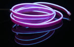 Coiled glowing purple LED neon rope light on a dark background.