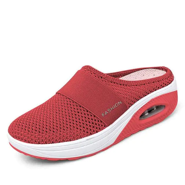 A single slip-on mesh sneaker with a white sole and air-cushion heel, featuring a breathable upper, an elastic band across the top for support, and the word “FASHION” printed on the side.