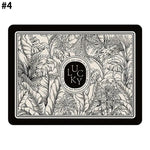 Rectangular decorative mat with a black border, detailed monochrome tropical leaf illustration, and a central circular emblem reading “Lucky,” set against a cream background.