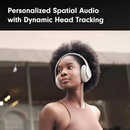 Woman wearing light-colored over-ear headphones looks to the side outdoors; banner text reads “Personalized Spatial Audio with Dynamic Head Tracking.