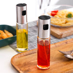 A photo of 2 kitchen condiment bottles placed inside a tray on a kitchen table