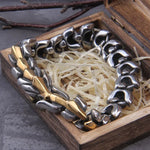 Two-tone chunky metal chain bracelet in a wooden gift box with shredded paper filler.