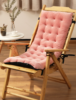 Wooden chair with a pink cushion on a wooden floor.