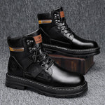 A pair of tan high-top boots with a thick jute-wrapped sole and colorful teddy bear patchwork fabric on the sides. The boots have a rugged design with metal eyelets and a branded patch on the side, displayed against a warm brown background.