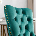 Teal upholstered chair with gold studs in a room setting