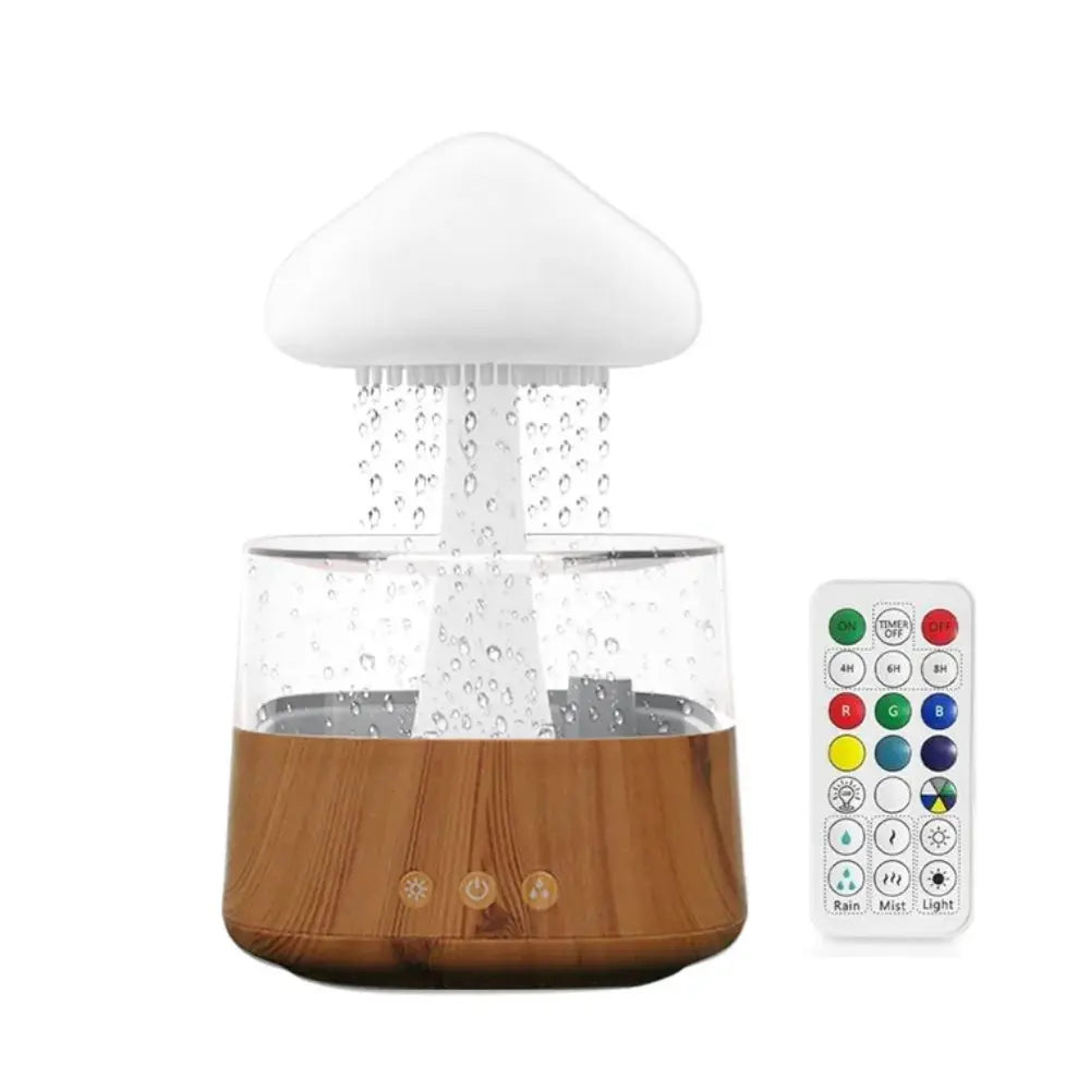 Cloud-shaped rain humidifier/aroma diffuser with a wood-grain base and clear water tank, shown dripping “rain” into the reservoir beside an RGB remote control.