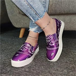 A vibrant red athletic sneaker featuring a breathable knit upper, lace-up design, and a unique, futuristic sole with hollowed cushioning pods for enhanced flexibility and support.