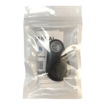 Small black device packaged in a clear resealable plastic bag with an instruction manual visible behind it.