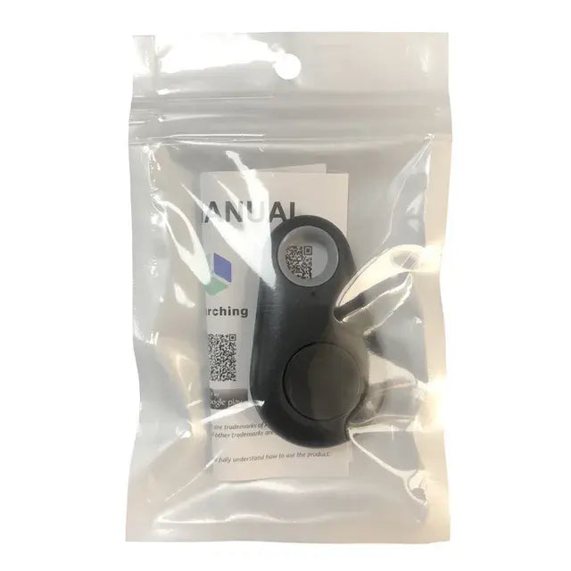 Small black device packaged in a clear resealable plastic bag with an instruction manual visible behind it.