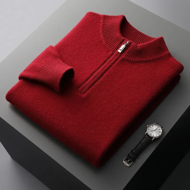 Folded sweat-shirt on a black box with a black leather watch beside it