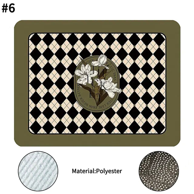 A black Super Absorbent Drain Pad placed on a kitchen countertop with a coffee maker and dishes in the background.