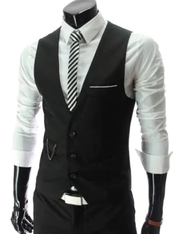 A formal black vest styled over a white dress shirt with a striped necktie, featuring a slim tailored fit, button front, and a small chain detail near the pocket.