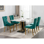 Dining room with a white table and teal chairs in a modern interior setting.