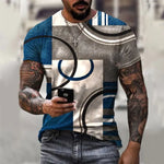 Tattooed man wearing a short-sleeve blue, gray, and white geometric-patterned T-shirt, holding a smartphone while walking outdoors.