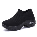 A vibrant red athletic sneaker featuring a breathable knit upper, lace-up design, and a unique, futuristic sole with hollowed cushioning pods for enhanced flexibility and support.
