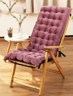 Wooden chair with a purple cushion on a wooden floor.