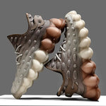 Brown and cream lace-up trainers with chunky bubble soles and dotted textured uppers.
