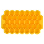 Yellow silicone ice cube tray with a honeycomb pattern of hexagonal compartments, shown on a white background.