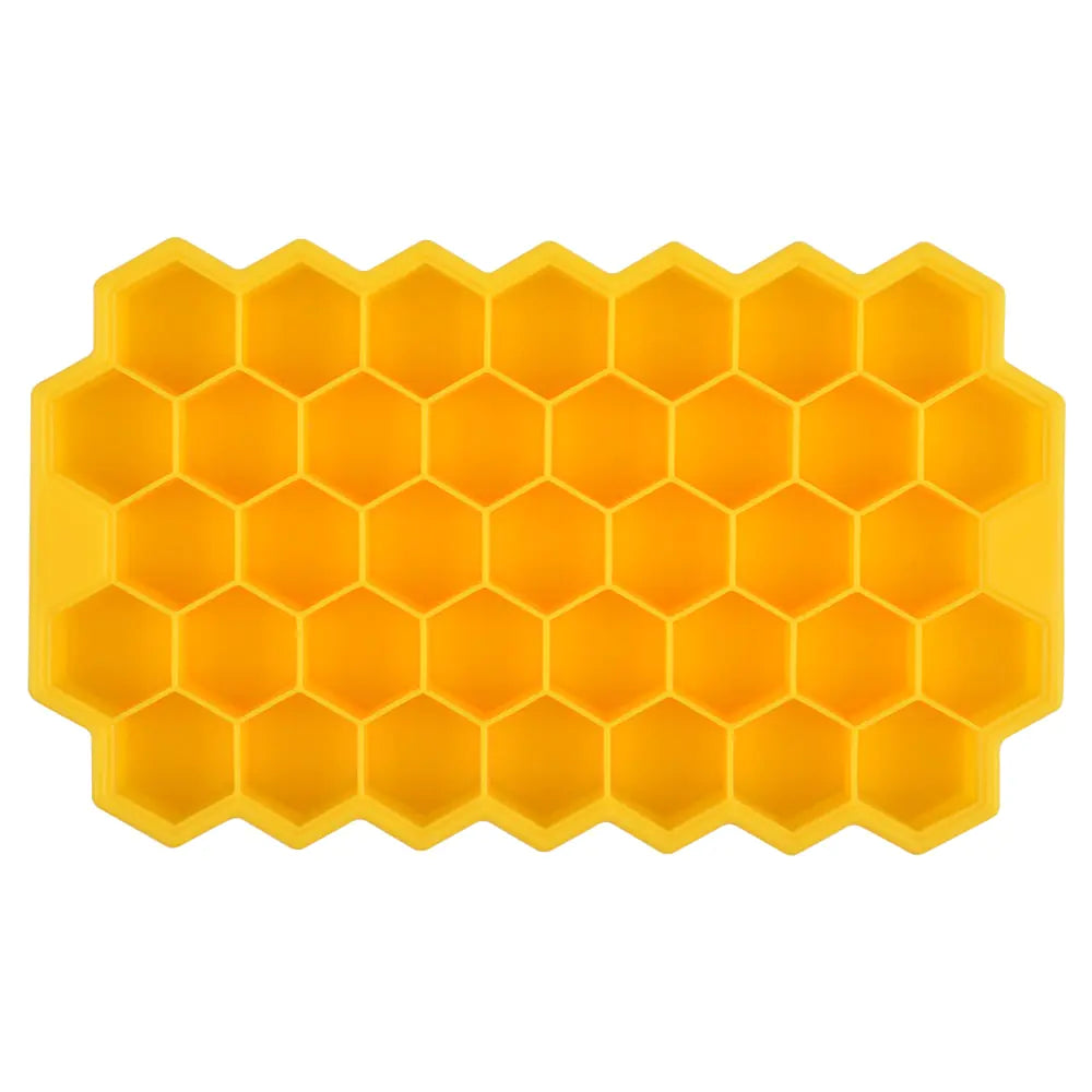 Yellow silicone ice cube tray with a honeycomb pattern of hexagonal compartments, shown on a white background.