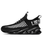 Black knit sneaker with white striped detailing, lace-up front, and a chunky cut-out sole.

