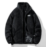 A stylish corduroy jacket with a plush fur-lined collar and inner lining is displayed against a white background. The jacket features a quilted black interior for added warmth, ribbed black cuffs and hem, and a zippered front closure. It has two side pockets, one of which has a small black and red tag. A subtle embroidered patch is visible on the left sleeve, adding a touch of detail to the design