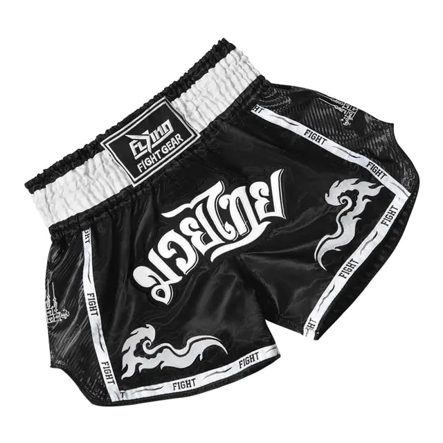 A pair of black Muay Thai boxing shorts with "FIGHT" written along the waistband and side, featuring embroidered dragon designs.