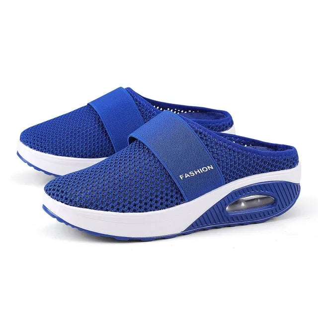 Blue mesh slip-on wedge mules with white platform soles.