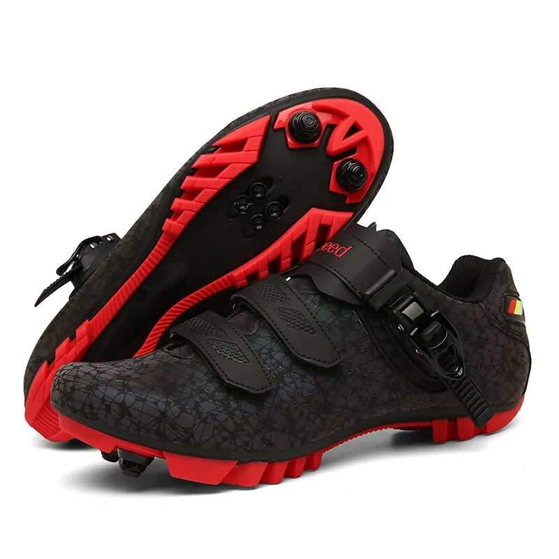 A pair of high-performance black  cycling shoes. The shoes feature a sleek design with three closure straps, including a secure ratchet strap. The upper has ventilated mesh sections and bright yellow line accents. The outsoles have cleat attachments and aggressive treads for grip, making them suitable for road or mountain biking. One shoe is upright while the other shows the sole with cleats and lug patterns.