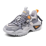 A black futuristic athletic sneaker with a knit-style upper, lace-up front, and high-top sock-like collar. It features a bold sculpted sole, a striking side cage design in beige and gray, and pull tabs at the tongue and heel for easier wear. The overall look is sleek, edgy, and streetwear-inspired, suited for casual fashion or sporty everyday use.